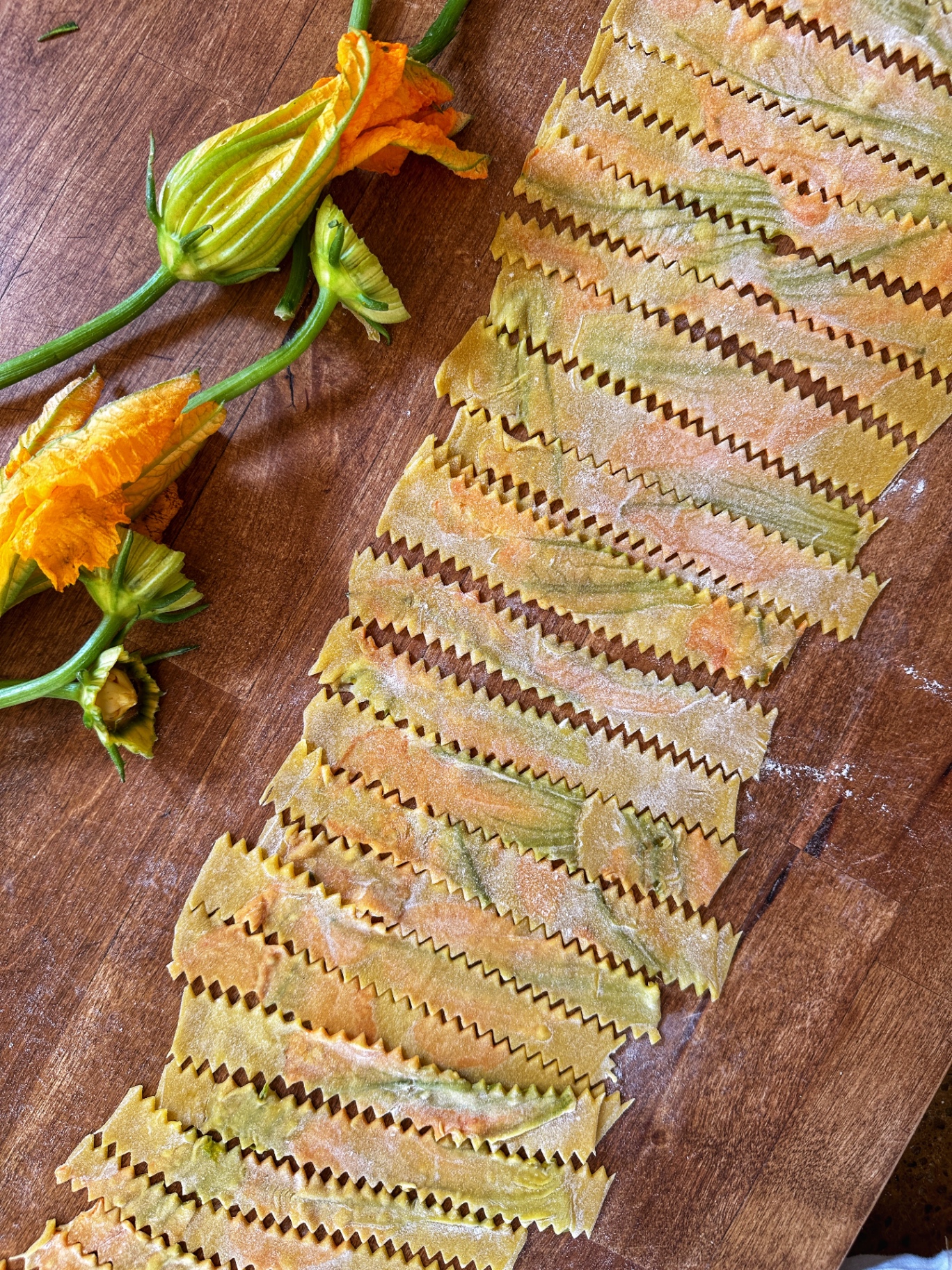 Ruffled pasta sheets pressed with squash blossoms