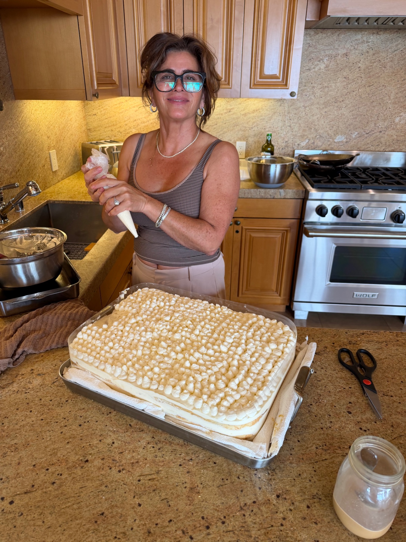 Fiona piping cream over a tiramisu tray